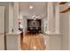 Bright dining room featuring hardwood floors, decorative columns, and a modern ceiling fan at 986 Franklin Ridge Ct, Sugar Hill, GA 30518