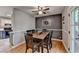 Inviting dining area features a dark accent wall, hardwood floors and access to the kitchen at 986 Franklin Ridge Ct, Sugar Hill, GA 30518