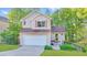 Charming two-story home with a well-manicured lawn, attached garage, and inviting front porch at 986 Franklin Ridge Ct, Sugar Hill, GA 30518