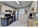 Galley style kitchen with granite countertops, stainless steel appliances, and contrasting blue cabinets at 986 Franklin Ridge Ct, Sugar Hill, GA 30518