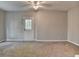 Spacious living room with neutral carpet, ceiling fan, and access to the backyard at 986 Franklin Ridge Ct, Sugar Hill, GA 30518