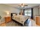 Spacious main bedroom featuring a ceiling fan, large window, and ensuite bathroom at 986 Franklin Ridge Ct, Sugar Hill, GA 30518