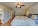 Spacious main bedroom featuring a ceiling fan and hardwood floors and attached bath and walk-in closet at 986 Franklin Ridge Ct, Sugar Hill, GA 30518