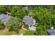 Aerial view of the property showcasing the home, mature trees and landscaping at 1156 Cotton Gin Ct, Lawrenceville, GA 30045