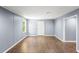 Finished basement featuring wood look floors, white trim and a door to the outside at 1156 Cotton Gin Ct, Lawrenceville, GA 30045