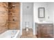 Bathroom with tile surround shower and tub, vanity and tile flooring at 1156 Cotton Gin Ct, Lawrenceville, GA 30045