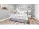 Cozy bedroom with natural light, neutral color scheme and wood-look flooring at 1156 Cotton Gin Ct, Lawrenceville, GA 30045