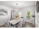 Elegant dining area with a modern chandelier, stylish decor, and ample natural light at 1156 Cotton Gin Ct, Lawrenceville, GA 30045