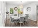 Bright dining room featuring stylish decor, modern light fixture, and large windows at 1156 Cotton Gin Ct, Lawrenceville, GA 30045