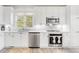 Bright kitchen featuring white cabinets, stainless steel appliances and modern backsplash at 1156 Cotton Gin Ct, Lawrenceville, GA 30045