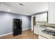 This kitchenette features white cabinets, granite countertops, stainless appliances and wood look floors at 1156 Cotton Gin Ct, Lawrenceville, GA 30045
