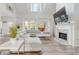 Inviting living room featuring high ceilings, a fireplace, and large windows offering plenty of natural light at 1156 Cotton Gin Ct, Lawrenceville, GA 30045
