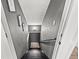 View of the gray staircase leading to the basement with decorative pictures on the wall at 1156 Cotton Gin Ct, Lawrenceville, GA 30045