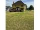Large backyard showing the house with a spacious deck, ideal for gatherings and enjoying the outdoors at 2246 Carrington Dr, Ellenwood, GA 30294