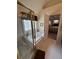 Bright bathroom showcasing a glass-enclosed shower, a soaking tub, and a glimpse into the bedroom at 2246 Carrington Dr, Ellenwood, GA 30294