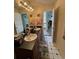 Hallway view into bathroom featuring double vanity and large mirror at 2246 Carrington Dr, Ellenwood, GA 30294
