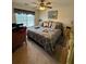 Comfortable bedroom featuring a ceiling fan, large window, and a cozy bed with patterned bedding at 2246 Carrington Dr, Ellenwood, GA 30294