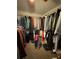 Walk-in closet with ample storage space, filled with clothes and personal belongings at 2246 Carrington Dr, Ellenwood, GA 30294