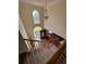 Grand foyer view from the top of the stairs featuring high ceilings, large windows, and a chandelier at 2246 Carrington Dr, Ellenwood, GA 30294