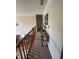 Second floor hallway featuring a decorative table with lamps and railing overlooking the entry foyer at 2246 Carrington Dr, Ellenwood, GA 30294