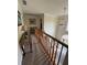 Spacious upstairs hallway with decorative lighting fixtures and railing overlooking the foyer at 2246 Carrington Dr, Ellenwood, GA 30294