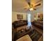 Cozy living room featuring comfortable sofas, a ceiling fan, and an inviting atmosphere for relaxation and entertainment at 2246 Carrington Dr, Ellenwood, GA 30294
