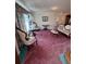 Cozy living room with pink carpet, traditional furnishings, and ample natural light at 2246 Carrington Dr, Ellenwood, GA 30294