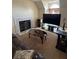 Cozy living room featuring a fireplace, a large TV, and a comfortable seating area at 2246 Carrington Dr, Ellenwood, GA 30294