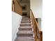 Carpeted staircase with wooden railing providing access to the upper levels of the home at 2246 Carrington Dr, Ellenwood, GA 30294