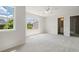 Bright bedroom with a ceiling fan, neutral carpet, and two large windows offering a backyard view at 3625 New River Ct, Cumming, GA 30040