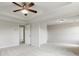 Spacious primary bedroom with carpet, ceiling fan, and tray ceilings at 3625 New River Ct, Cumming, GA 30040