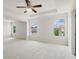 Large bedroom with tray ceiling, ceiling fan, and bright windows at 3625 New River Ct, Cumming, GA 30040