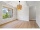 Empty dining room with elegant chandelier, white trim and hardwood floors at 3625 New River Ct, Cumming, GA 30040