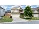 Two-story home with manicured lawn and front-facing two-car garage at 3625 New River Ct, Cumming, GA 30040