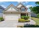 Charming two-story home with a two-car garage and manicured landscaping at 3625 New River Ct, Cumming, GA 30040