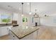 Open concept kitchen with granite island flowing into a cozy living area at 3625 New River Ct, Cumming, GA 30040