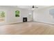 Bright living room with fireplace, ceiling fan, and plenty of natural light at 3625 New River Ct, Cumming, GA 30040