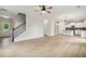 Open-concept living space with hardwood floors, staircase and adjoining kitchen at 3625 New River Ct, Cumming, GA 30040