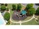 This aerial shot showcases a playground with modern equipment, a shade structure, and easy access to other amenities at 3625 New River Ct, Cumming, GA 30040
