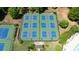 Aerial view showcases meticulously maintained tennis and pickleball courts, with lush landscaping and ample parking at 3625 New River Ct, Cumming, GA 30040