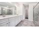 Bathroom featuring double sink vanity and glass-enclosed shower at 5749 Creek Indian Dr, Sugar Hill, GA 30518