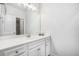 Well-lit bathroom featuring a large mirror, modern sink, and white cabinets at 5749 Creek Indian Dr, Sugar Hill, GA 30518