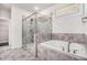 Elegant bathroom featuring a soaking tub and separate glass-enclosed shower at 5749 Creek Indian Dr, Sugar Hill, GA 30518