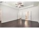 Spacious bedroom with a tray ceiling, ceiling fan, and ensuite bathroom at 5749 Creek Indian Dr, Sugar Hill, GA 30518