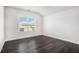 This bedroom features beautiful dark wood floors and a bright window at 5749 Creek Indian Dr, Sugar Hill, GA 30518