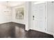 Bright entryway with dark wood floors, white wainscoting, and a view to a dining area at 5749 Creek Indian Dr, Sugar Hill, GA 30518