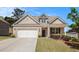 Charming single-Gathering home with a brick facade, manicured lawn, and a two-car garage at 5749 Creek Indian Dr, Sugar Hill, GA 30518