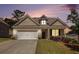Charming one-story brick home featuring a well-manicured lawn and an attached two-car garage at 5749 Creek Indian Dr, Sugar Hill, GA 30518