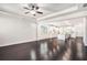 Open-concept living space connecting the living room and kitchen with dark hardwood floors throughout at 5749 Creek Indian Dr, Sugar Hill, GA 30518