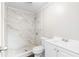 Stylish bathroom with marble shower, white vanity, and modern fixtures at 60 Highland Dr, Stockbridge, GA 30281